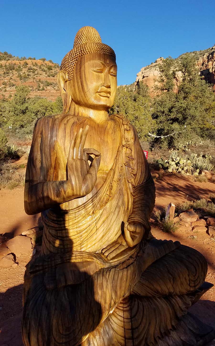 Carved Wooden Shakyamuni statue at Amitabha stupa site in Sedona Arizona