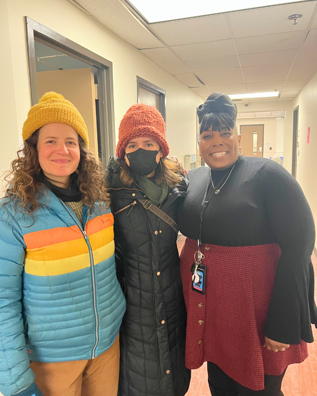 Group photo: two Buddhist Relief volunteers with a volunteer from EveryMind, all smiling.